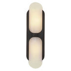 Clérachic Alabaster Wall Sconce in the tall size with a black bracket, the lit stone glowing white between dark metal edges.