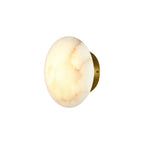 Side view of the Clérachic Alabaster Wall Sconce, the brushed brass backplate visible behind the lit stone disc.