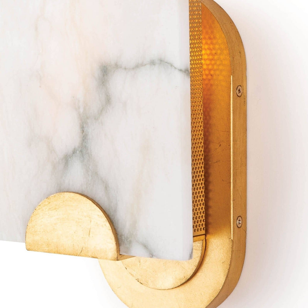 Close view of the Clérachic Alabaster Wall Sconce, amber light escaping the perforated brass panel beside the oval wall plate.