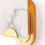 Close view of the Clérachic Alabaster Wall Sconce, amber light escaping the perforated brass panel beside the oval wall plate.