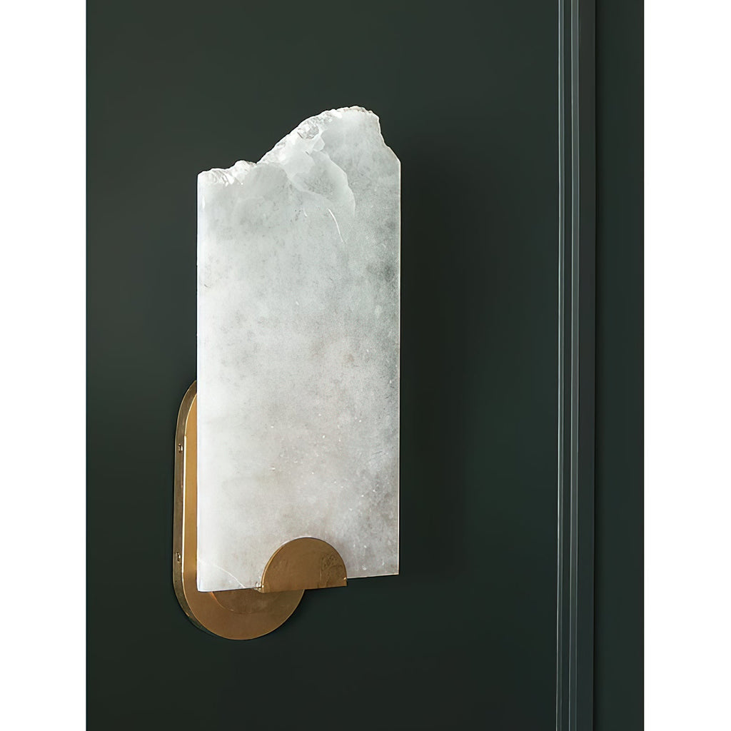 Clérachic Alabaster Wall Sconce mounted on a deep green hallway wall beside a panelled door frame.