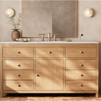 A pair of Clérachic alabaster sconces mounted either side of a mirror above an oak cabinet, throwing an even light across the wall.