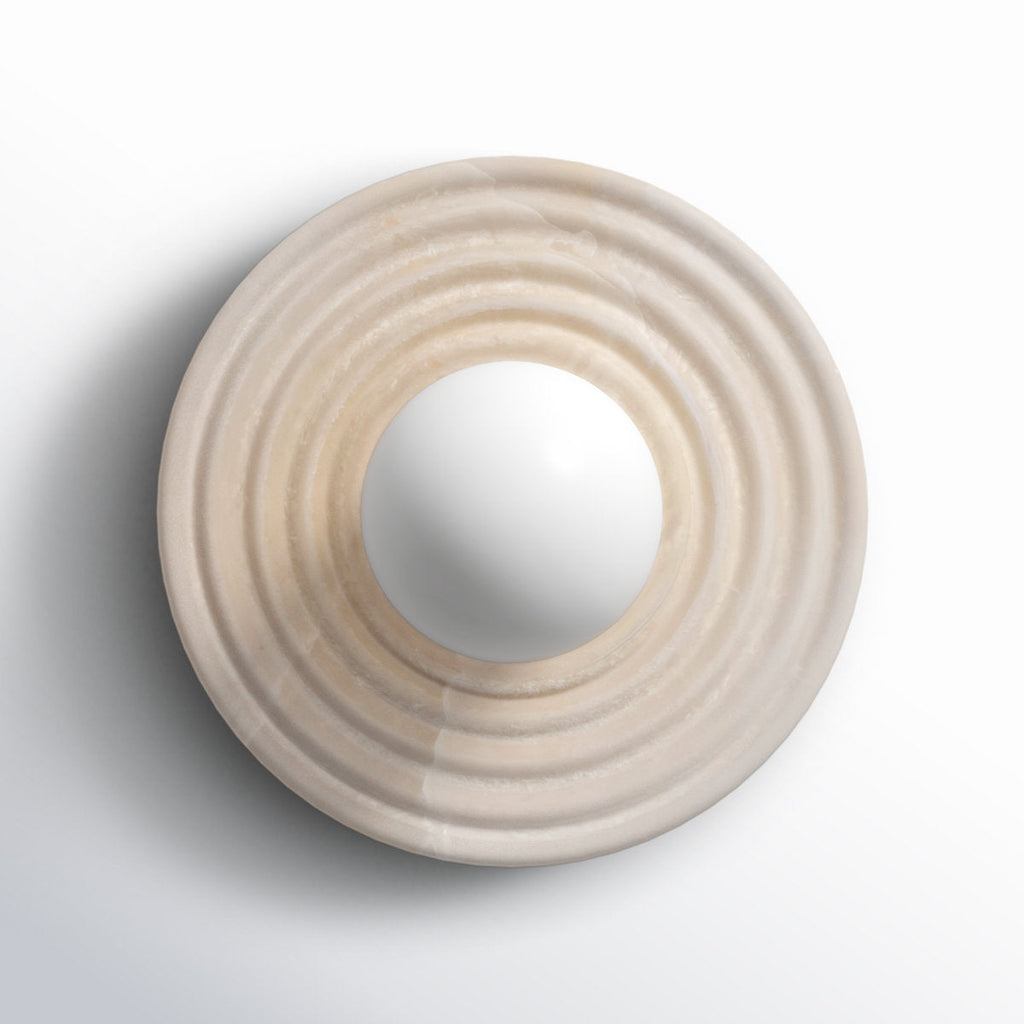 The alabaster disc of the Clérachic wall sconce shown alone face-on, concentric rings turned around an open centre for the socket.
