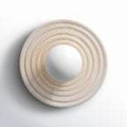The alabaster disc of the Clérachic wall sconce shown alone face-on, concentric rings turned around an open centre for the socket.