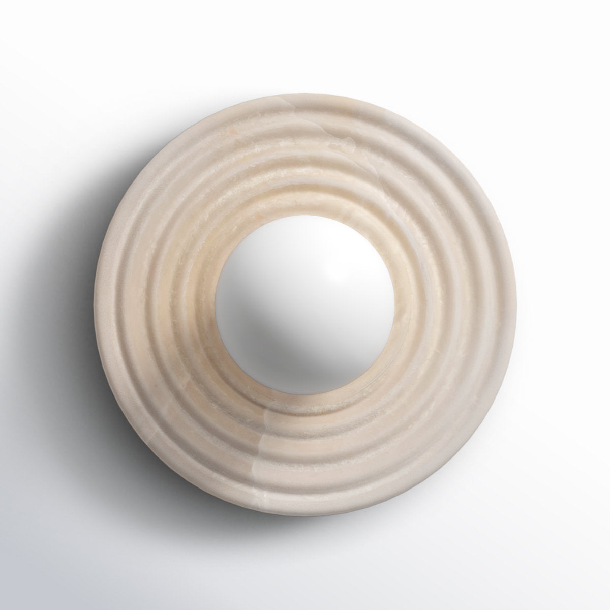 The alabaster disc of the Clérachic wall sconce shown alone face-on, concentric rings turned around an open centre for the socket.