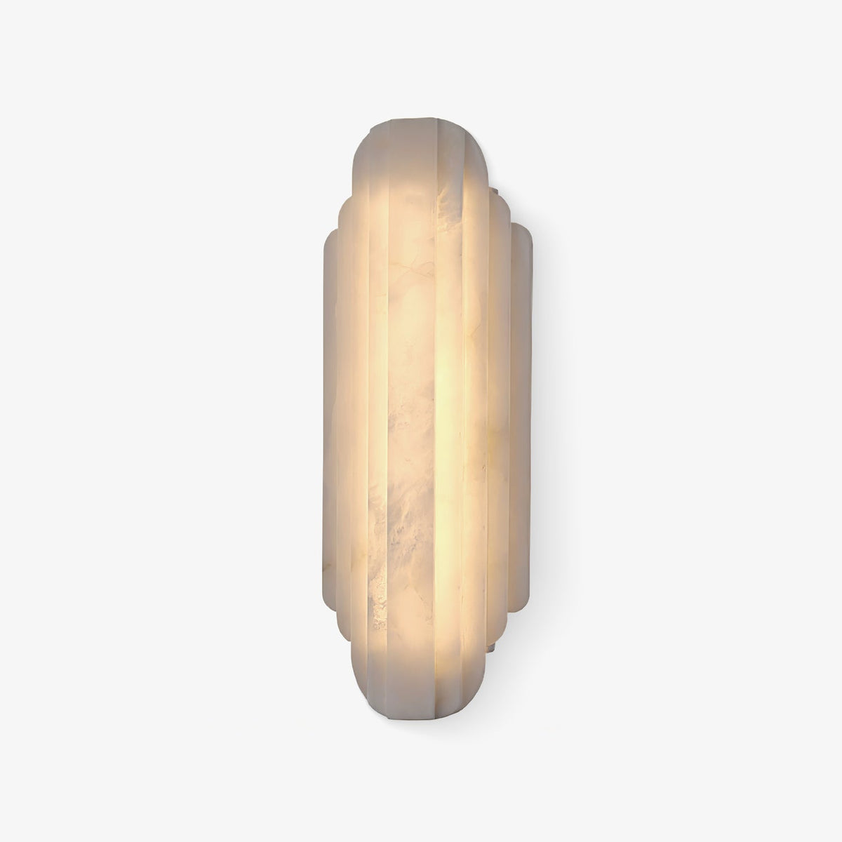The taller Clérachic alabaster sconce lit warm on a white backdrop, with a darker band of veining running down the stone.