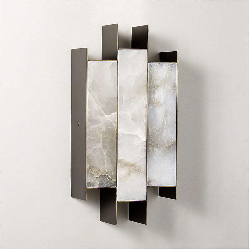 Clérachic Alabaster Wall Sconce unlit on a wall, the cool grey-white veining of its three natural stone panels on show.