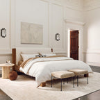 A pair of Clérachic Alabaster Wall Sconces flanking the bed in a panelled bedroom, one either side of the artwork.