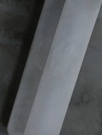 Close view of the Clérachic Alabaster Wall Sconce where one plate steps in front of the other, the seam running the full height of the stone.