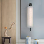 Clérachic Alabaster Wall Sconce lit beside a framed blue panel in an entry, throwing a soft wash up and down the wall.