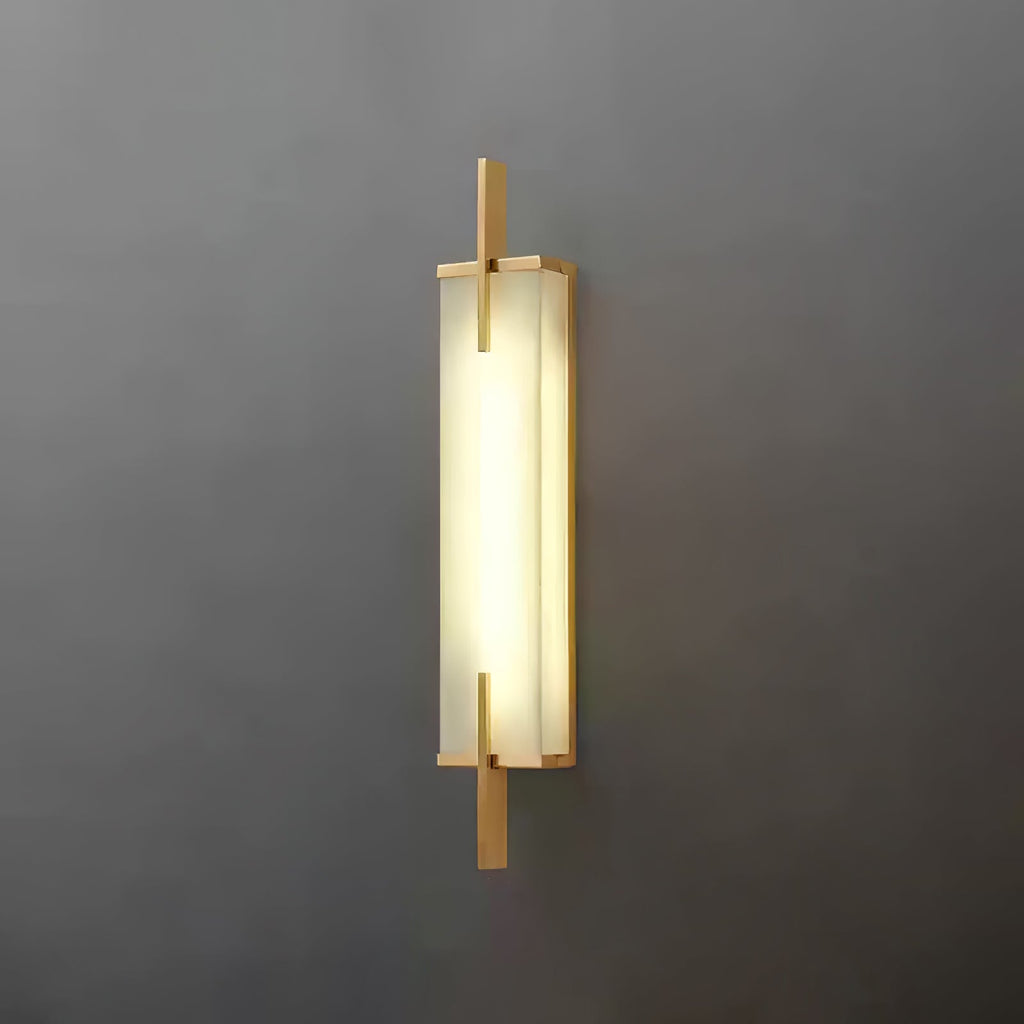 A Clérachic wall light with a gold-toned frame and a bright, evenly glowing panel, mounted on a dark grey wall.