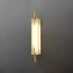 A Clérachic wall light with a gold-toned frame and a bright, evenly glowing panel, mounted on a dark grey wall.