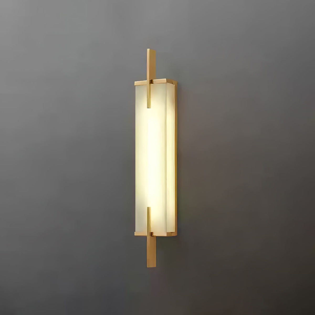 A Clérachic wall light with a gold-toned frame and a bright, evenly glowing panel, mounted on a dark grey wall.