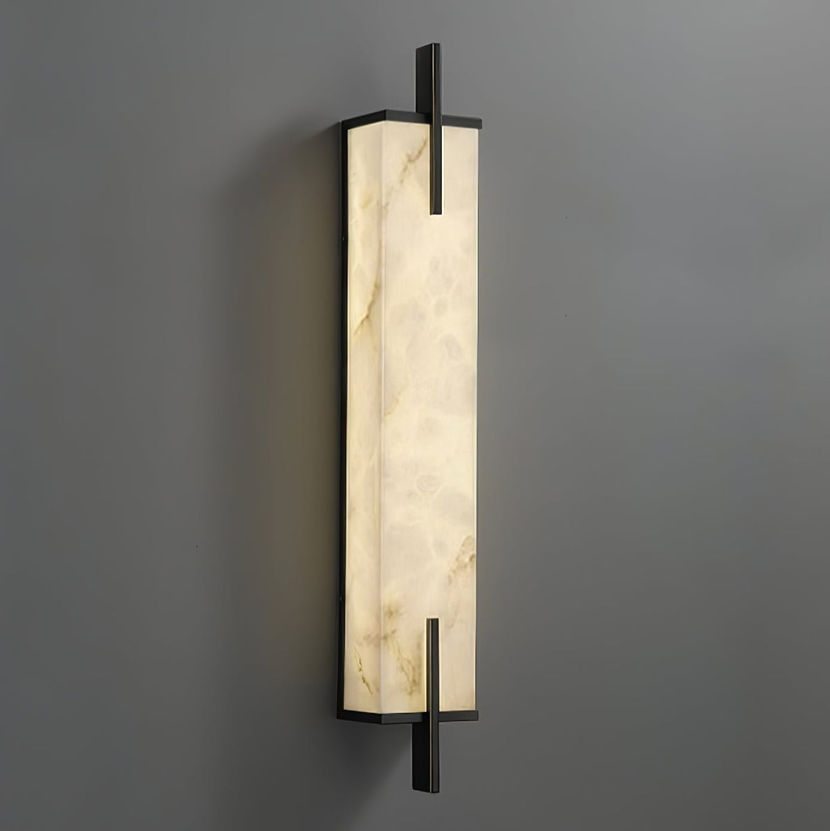 Close angled view of this Clérachic alabaster wall light, showing deep veining in the stone and a slim black frame.