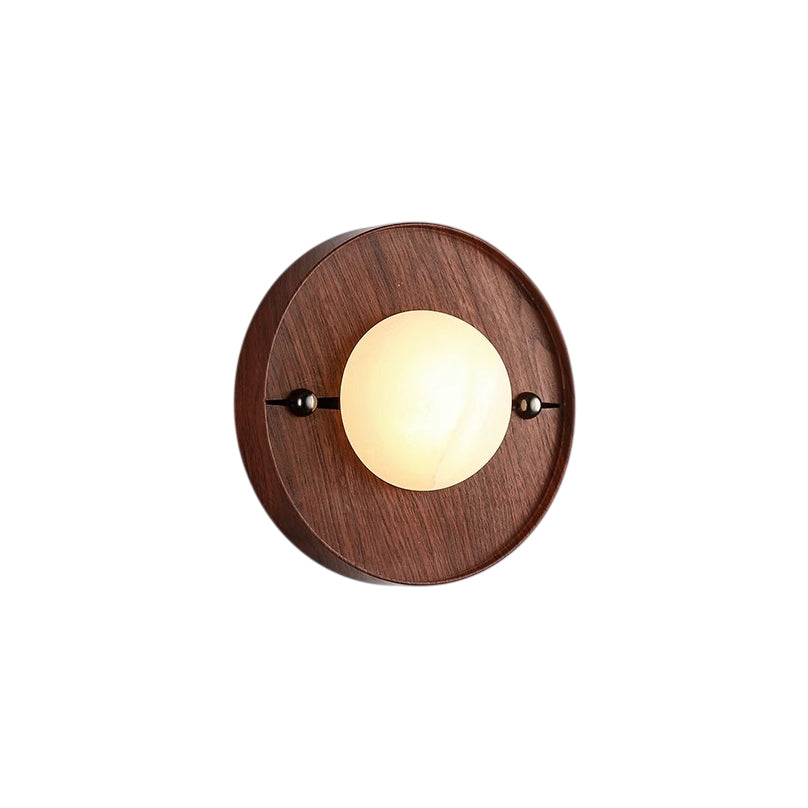 Round Clérachic Alabaster Wall Sconce seen straight on, its shallow walnut disc standing only a little proud of the wall.