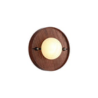 Round Clérachic Alabaster Wall Sconce seen straight on, its shallow walnut disc standing only a little proud of the wall.