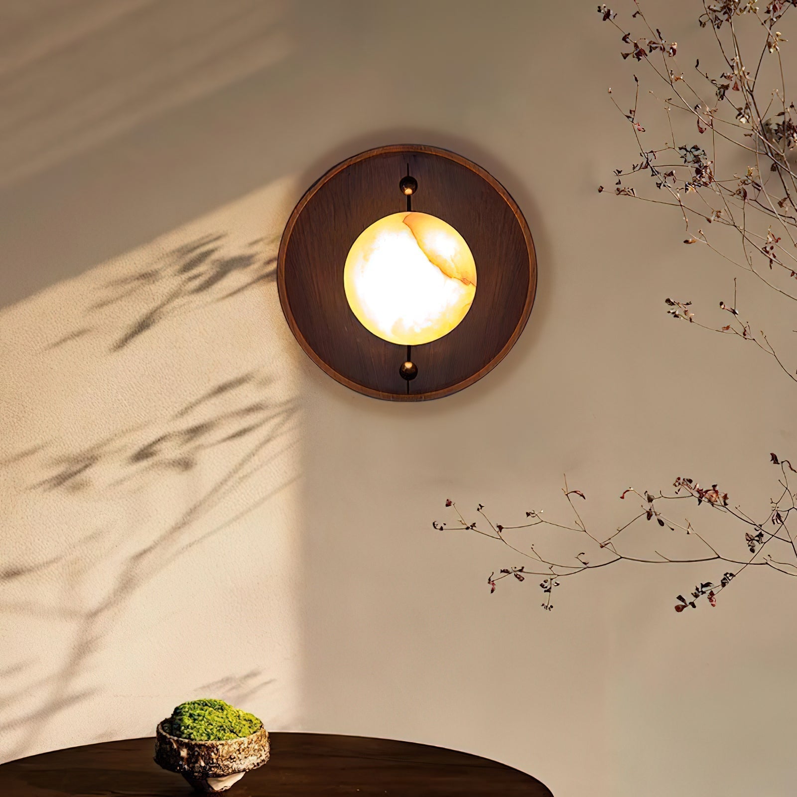 Close view of the lit Clérachic Alabaster Wall Sconce, amber veining running across the glowing stone in its round walnut surround.