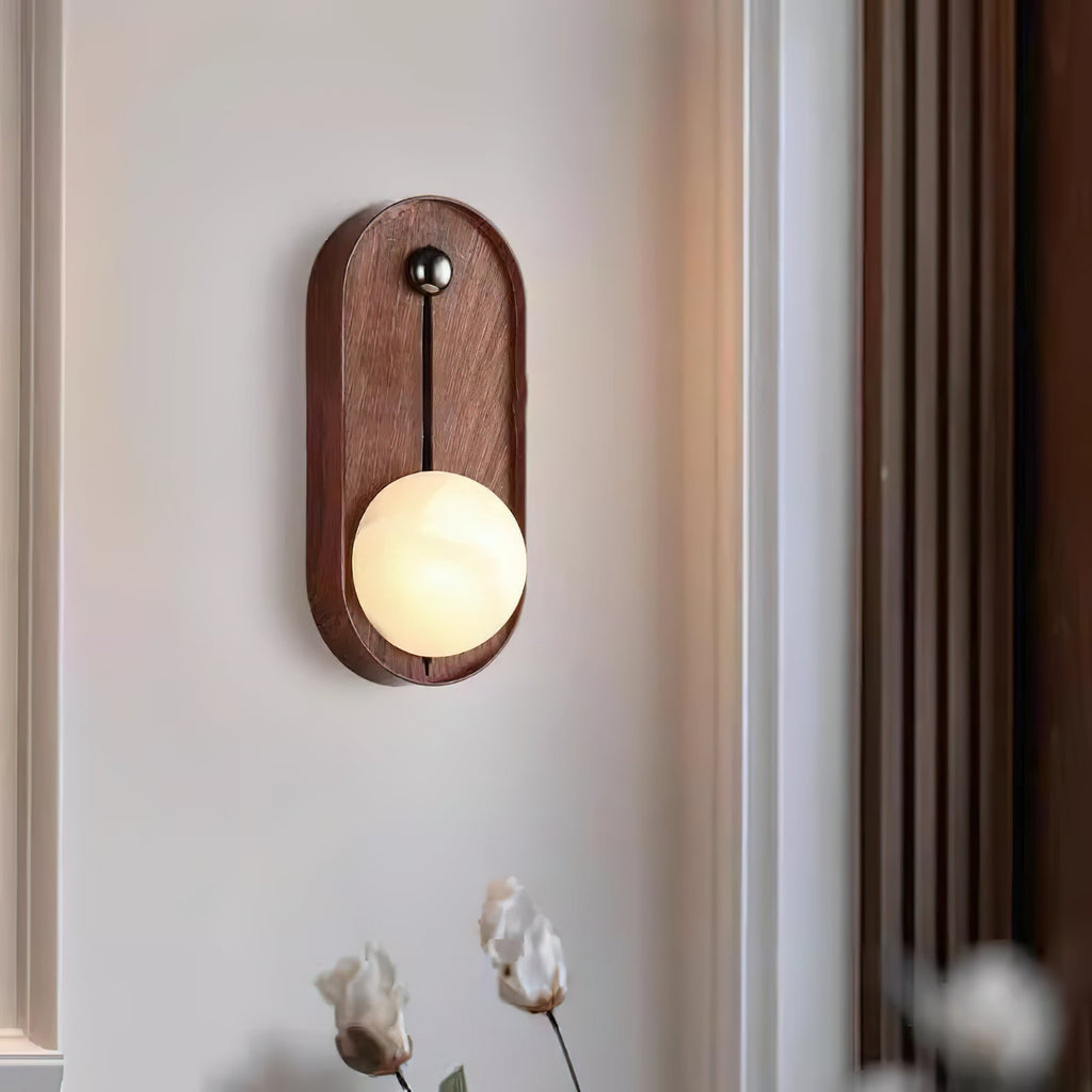 Oval Clérachic Alabaster Wall Sconce mounted on white panelling, its lit globe standing just 8 cm (3.1 in) off the wall.