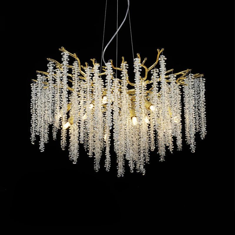 The Clérachic Albero chandelier fuller on black, crystal strands hung densely under gold branches.