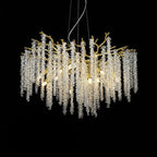 The Clérachic Albero chandelier fuller on black, crystal strands hung densely under gold branches.