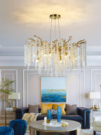 Clérachic Albero chandelier lit in a classical room above a navy sofa and a seascape painting.