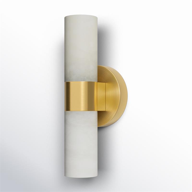 The Clérachic Alight sconce turned slightly, its brass band catching the light where it grips the alabaster tube.
