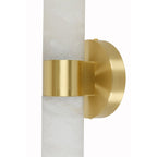 Clérachic Alight wall lamp in macro, the brushed brass band and its mounting stem meeting the alabaster tube.