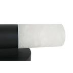 The Clérachic Alight sconce cropped tight, black collar meeting the alabaster tube where it cantilevers off the wall.