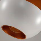 Close view of the white shade's opening, with its brushed gold interior and bulb visible, on this Clérachic pendant.