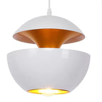Close view of a white pendant with a gold interior, its upper dome lifted above the lit lower bowl, from Clérachic.