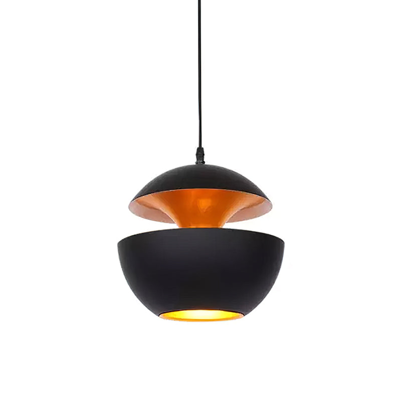 Smaller black pendant with a gold interior and a lit opening below, hung on a black cord, from Clérachic.