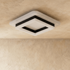Clérachic stacked square flush light with a black frame and frosted white acrylic tiers, shown unlit against a limewash ceiling.