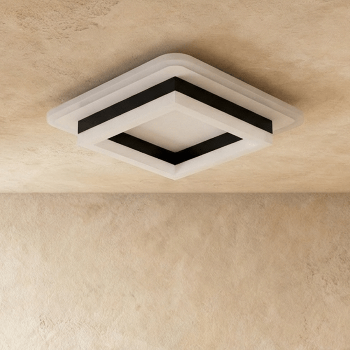Clérachic stacked square flush light with a black frame and frosted white acrylic tiers, shown unlit against a limewash ceiling.
