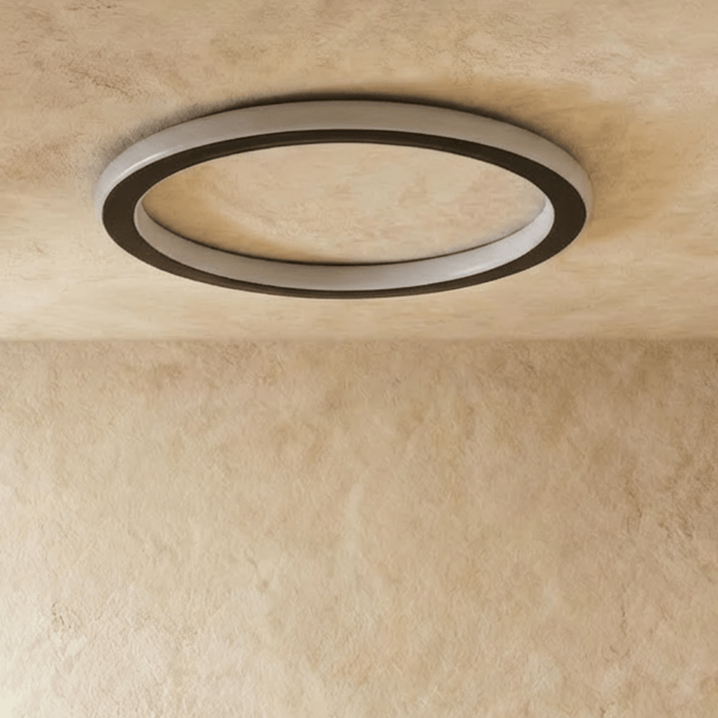Clérachic slim round ceiling ring in black with a frosted white acrylic band, switched off against a limewash ceiling.