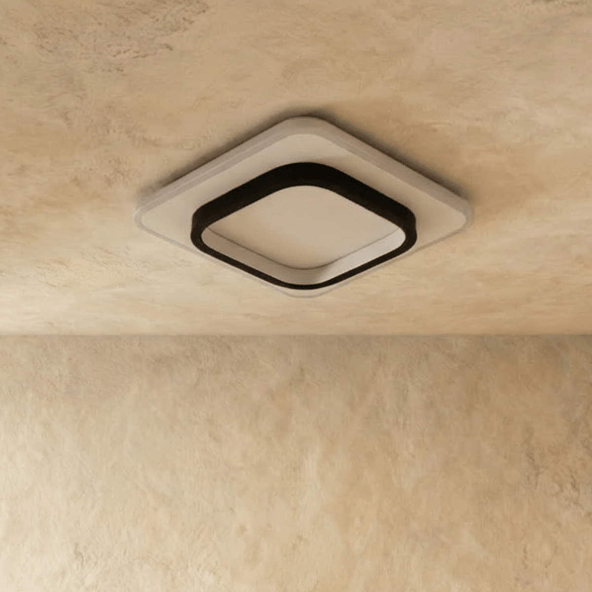 Clérachic rounded-square flush ceiling light in black and white acrylic, shown switched off against a limewash ceiling.