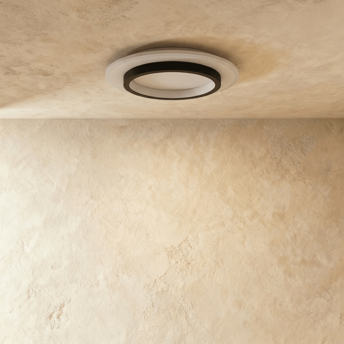 Clérachic round flush ceiling light with a black ring and white acrylic disc, shown unlit against a limewash ceiling.