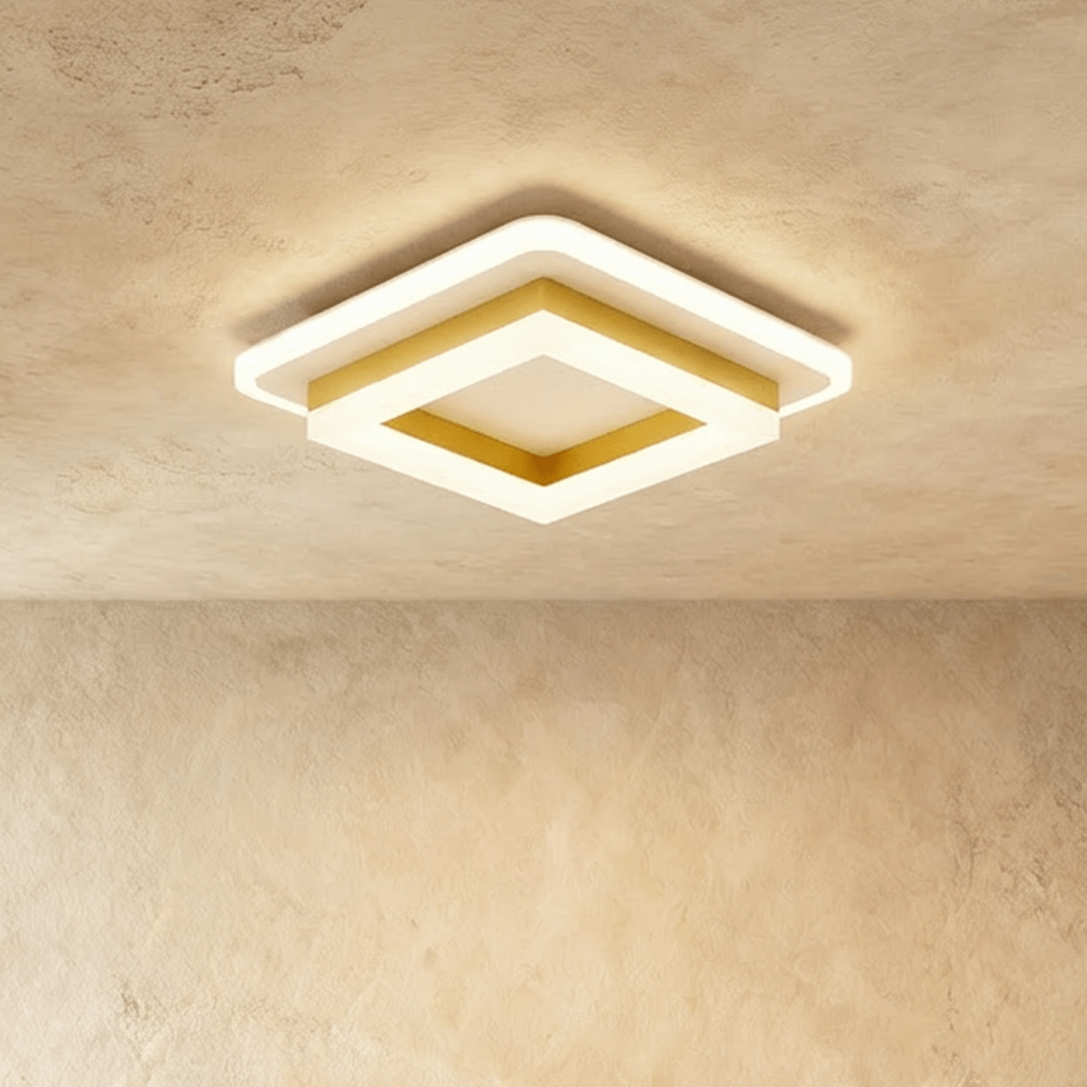 Clérachic stacked square ceiling light with a gold-finish frame and frosted white acrylic tiers, glowing warm on a ceiling.