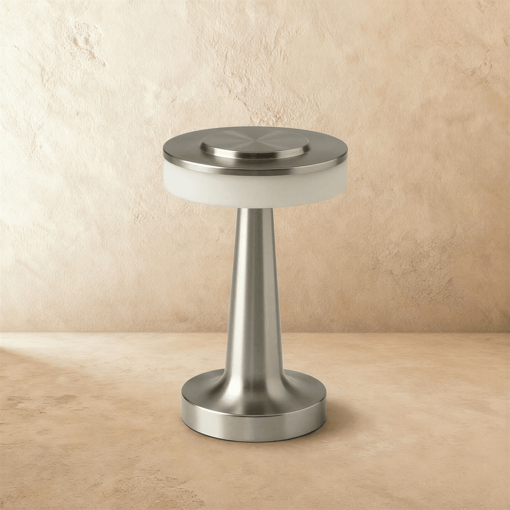 Clérachic cordless table lamp in brushed silver, unlit, showing the opal diffuser band under its flat metal disc top