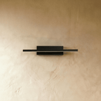 Clérachic black bar wall light switched off, showing its slim matte black aluminium arm and rectangular wall plate.