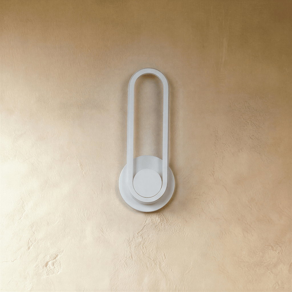 Clérachic white oval ring wall light switched off, a slim loop on a round backplate against a textured limewash wall.