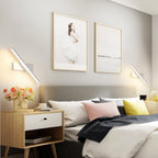 Clérachic pair of white bar wall lights angled at either side of a bed, one above each side of the grey headboard.