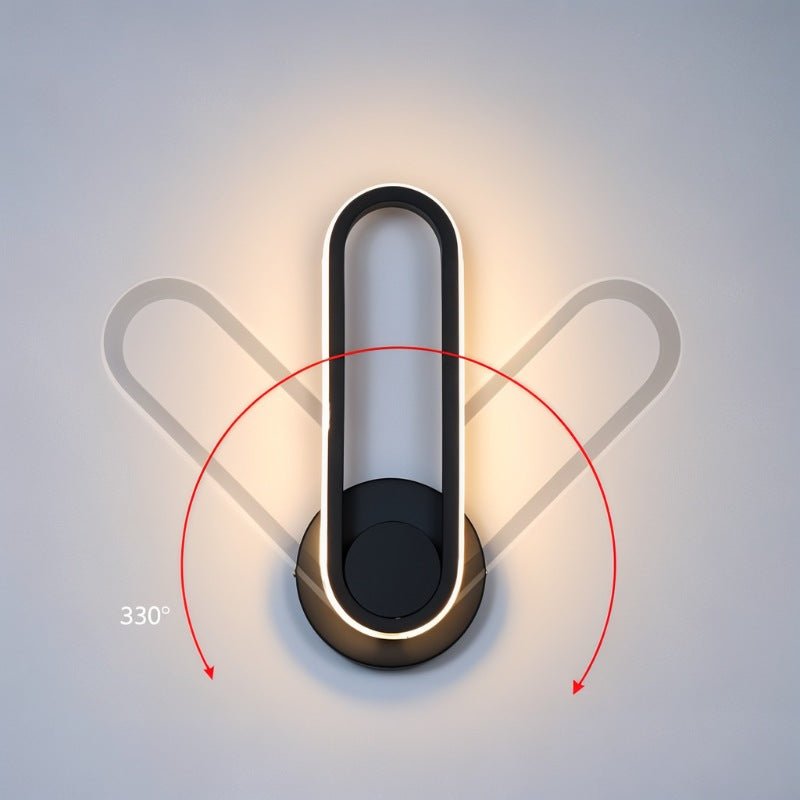 Clérachic black oval ring wall light shown upright with ghosted positions and a red arc marking its swivel range.