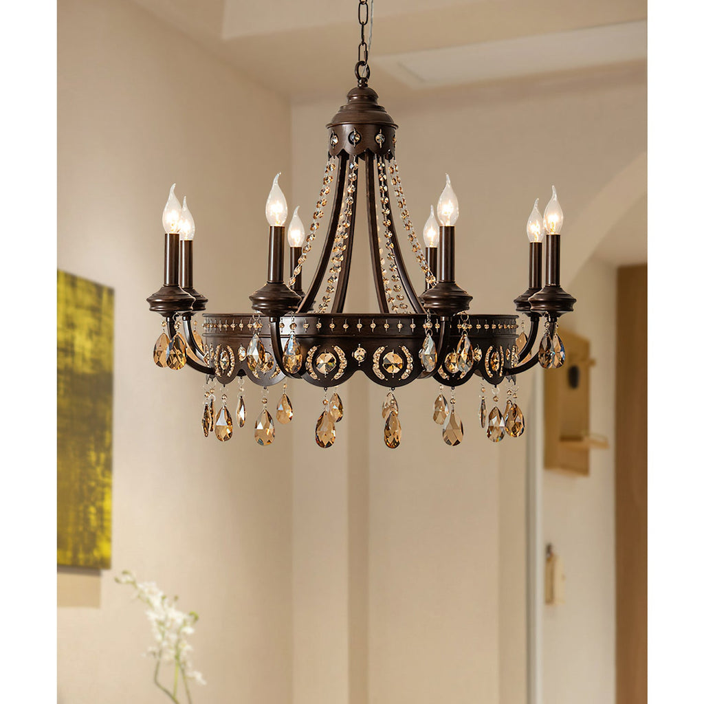 Clérachic chandelier with amber crystal drops lit in a pale hallway, with an arched doorway and a painting at the edge.