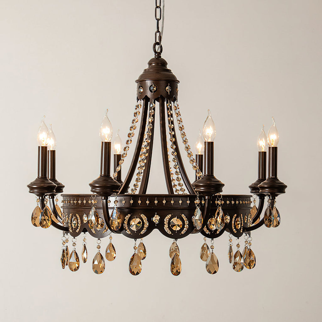 Bronze-finish Clérachic chandelier with amber crystals and six candle lights, lit against a plain beige wall.