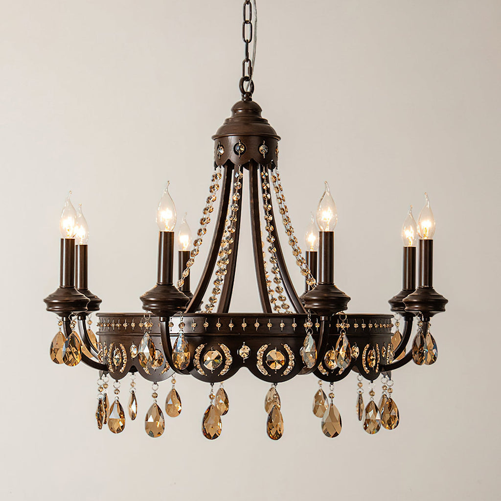 Lit Clérachic chandelier with a dark bronze-finish frame, beaded crystal garlands and amber teardrop crystals, on a cream wall.