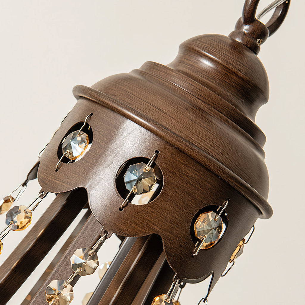 Close view of the bronze-finish canopy of this Clérachic chandelier, set with round crystal inserts and hung with crystal strands.