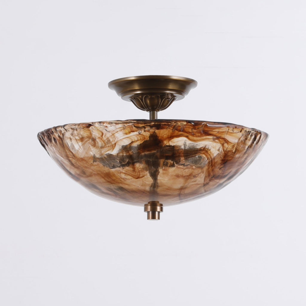 Side-on view of this Clérachic ceiling light, with the wide, shallow amber glass bowl and bronze fitting against a soft grey background.