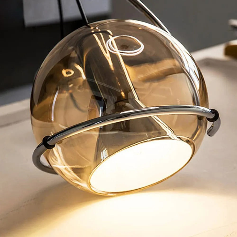 Close-up of the Clérachic Amber Glass Dome Pendant Light, warm light spilling from the white diffuser at its base.