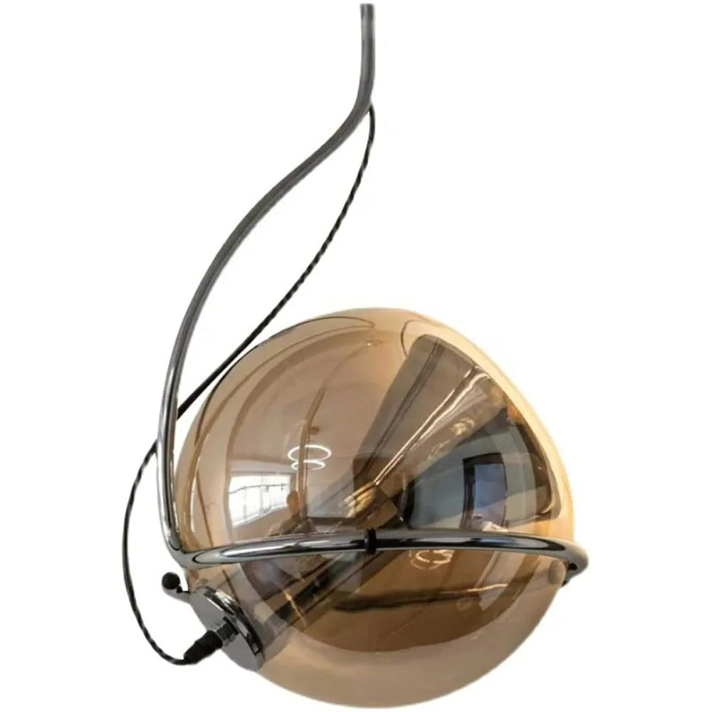 Studio view of the Clérachic Amber Glass Dome Pendant Light, a chrome arm wrapping the amber globe on white.