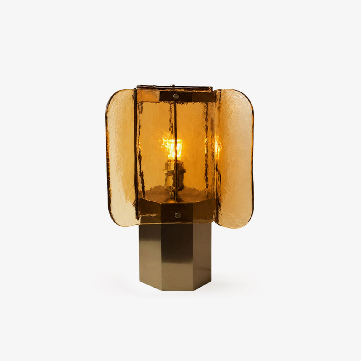 Four wavy amber glass panels around a lit bulb, this Clérachic table lamp sits on an octagonal brass base against a plain white backdrop.